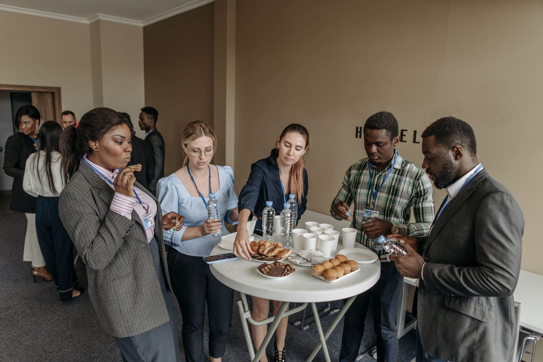 Prominent business professionals networking and enjoying refreshments at a conference.